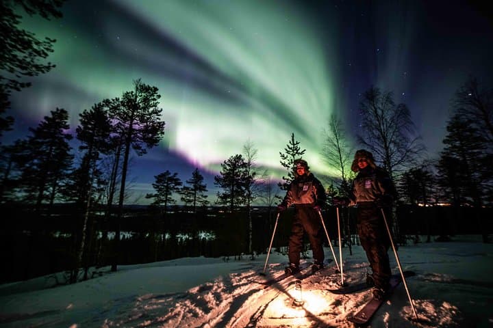 Northern Lights show and happy skiers