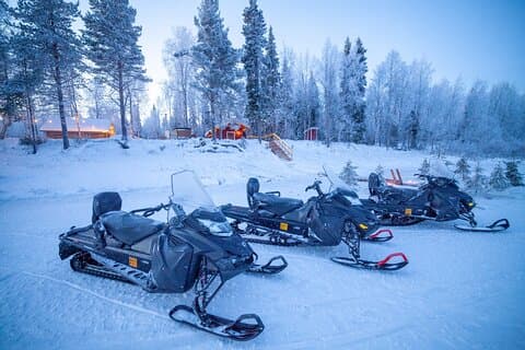 Snowmobiles parked outside our Riverside Sauna