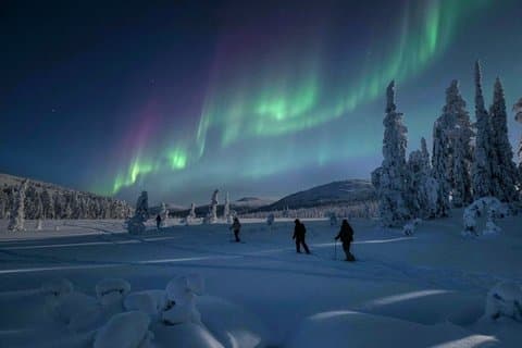 Ylläs: Northern Lights Skiing Across a Frozen Lake