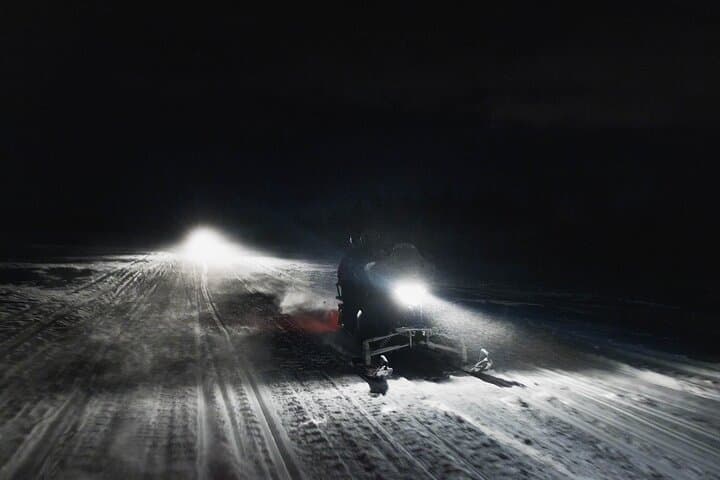 Northern lights safari by snowmobile