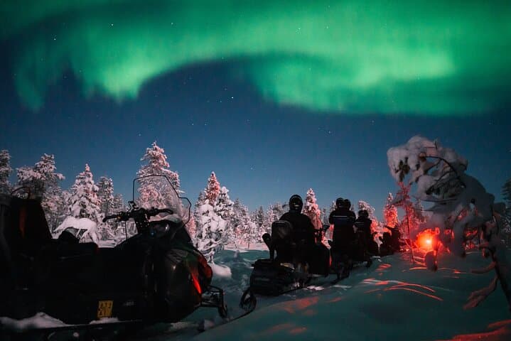 Northern lights safari by snowmobile