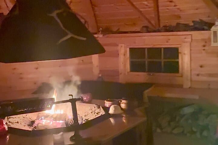 Warm up by the fire inside a traditional wooden kota after the night adventure.