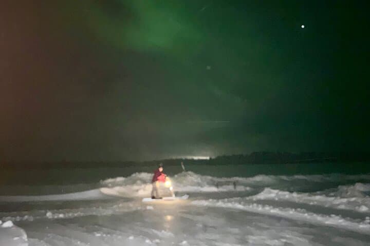 Search for the Northern Lights on a frozen lake with a traditional Finnish kick sled.